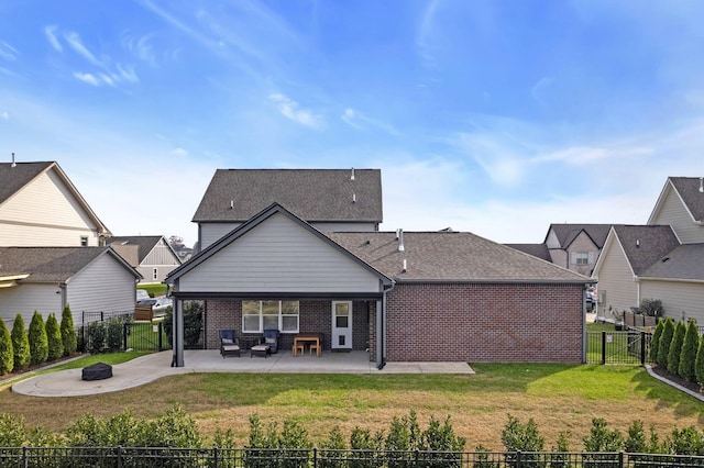 back of house featuring a yard, a patio, and an outdoor fire pit