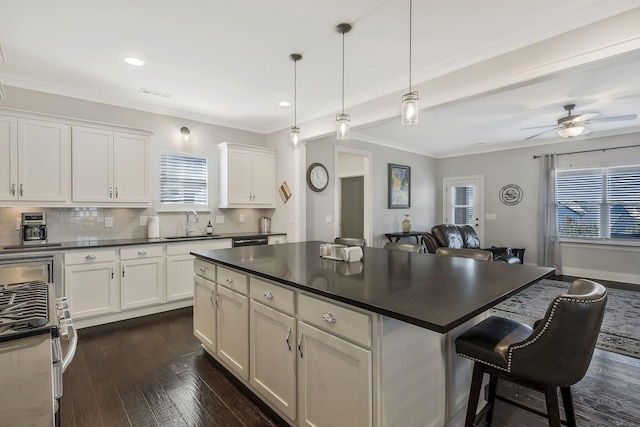 kitchen with ceiling fan, dark hardwood / wood-style floors, backsplash, pendant lighting, and white cabinets