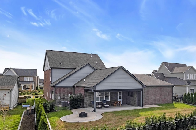 back of property featuring a fire pit, a patio area, and a lawn