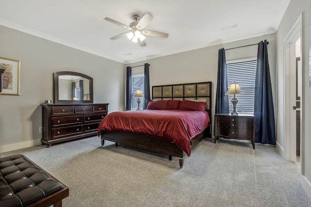 carpeted bedroom featuring ceiling fan and crown molding