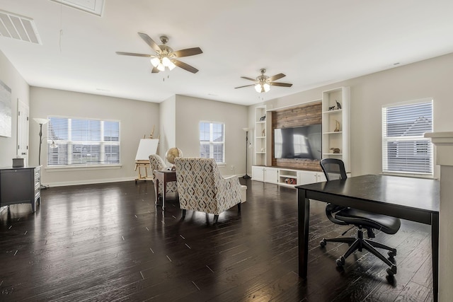 interior space featuring dark hardwood / wood-style flooring, ceiling fan, and plenty of natural light