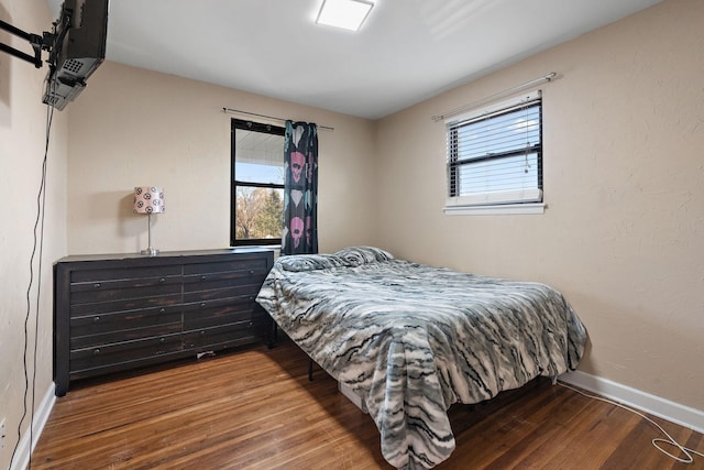 bedroom featuring hardwood / wood-style flooring and multiple windows