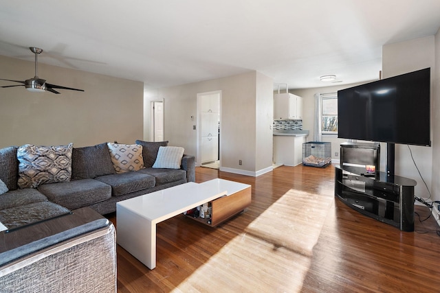 living room featuring ceiling fan and wood-type flooring