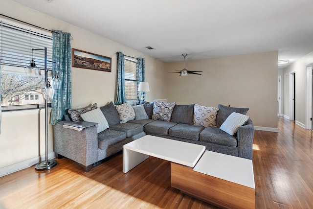 living room featuring ceiling fan and wood-type flooring