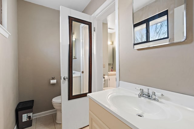 bathroom with tile patterned floors, vanity, and toilet