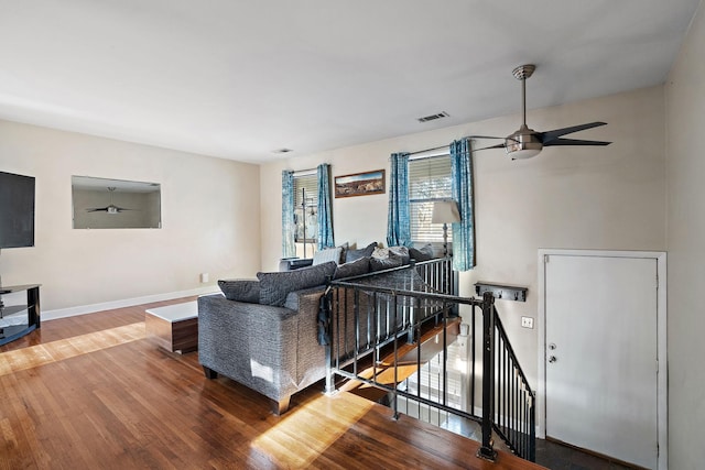 living room featuring ceiling fan and hardwood / wood-style floors