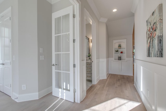 hall featuring built in features and light wood-type flooring