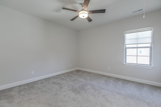 empty room featuring light colored carpet and ceiling fan