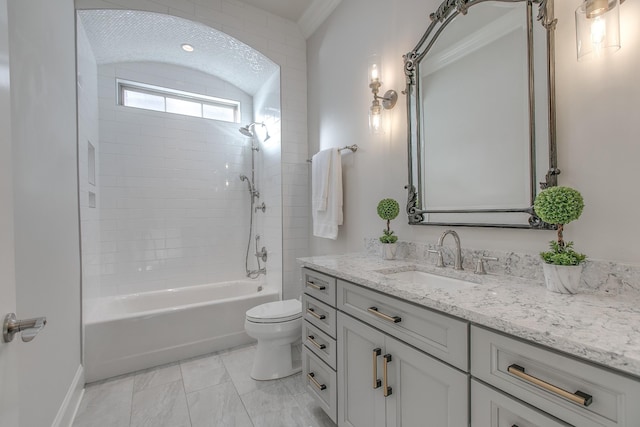 full bathroom with vanity, tiled shower / bath, and toilet