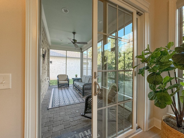 sunroom featuring ceiling fan