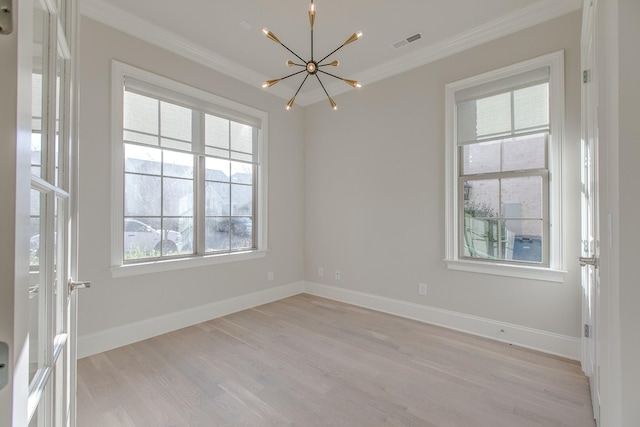 unfurnished room featuring crown molding, an inviting chandelier, and light wood-type flooring