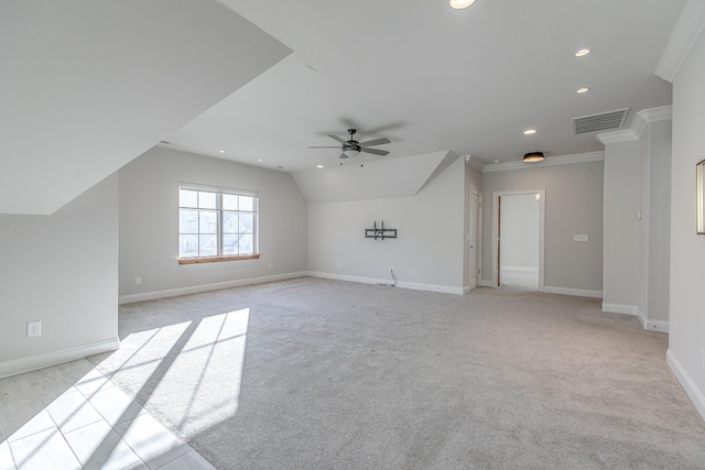 additional living space with vaulted ceiling, light colored carpet, and ceiling fan