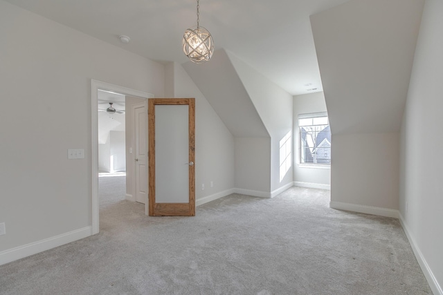 additional living space featuring light colored carpet and vaulted ceiling