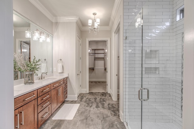 bathroom with a notable chandelier, ornamental molding, vanity, and walk in shower