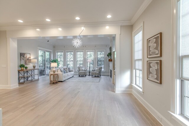 interior space featuring ornamental molding and light wood-type flooring