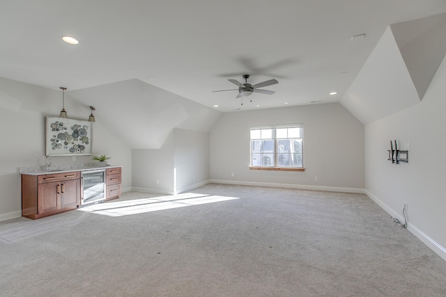 bonus room with lofted ceiling, light colored carpet, indoor wet bar, ceiling fan, and beverage cooler