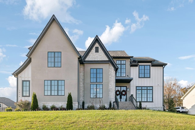 view of front of property featuring a front yard and french doors