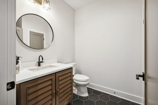 bathroom with tile patterned floors, vanity, and toilet