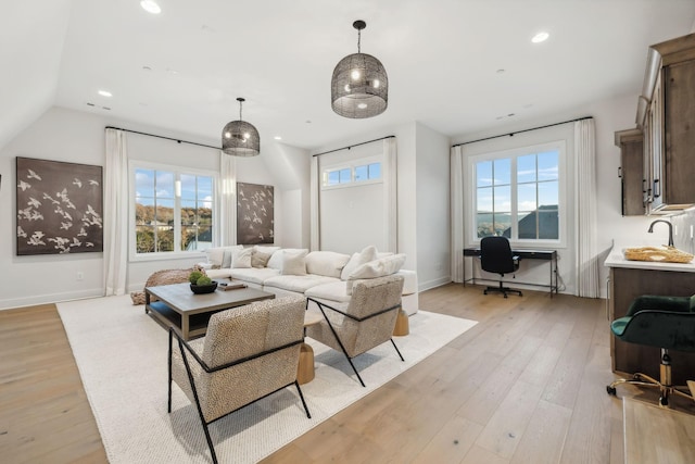 living room featuring a wealth of natural light and light hardwood / wood-style floors