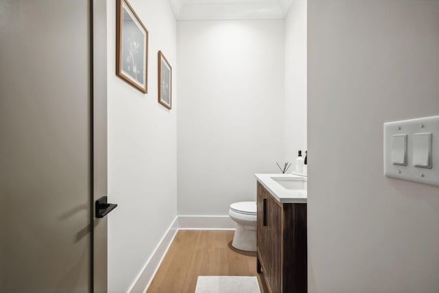 bathroom featuring hardwood / wood-style floors, vanity, and toilet