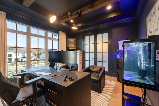 office area featuring a raised ceiling, french doors, ornamental molding, and light wood-type flooring