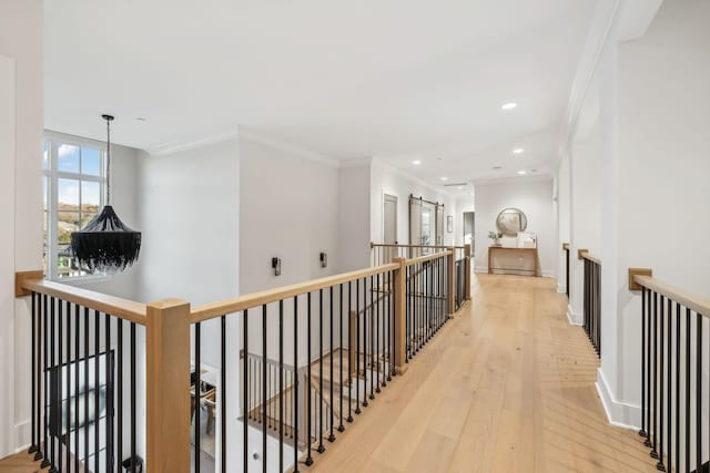 corridor featuring light hardwood / wood-style floors and ornamental molding