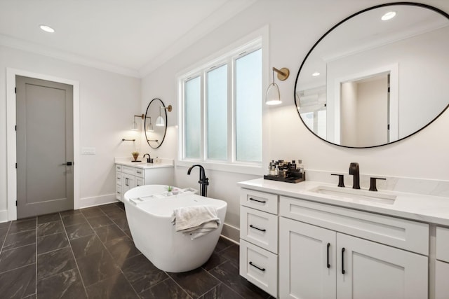 bathroom featuring a healthy amount of sunlight, vanity, crown molding, and a bathing tub