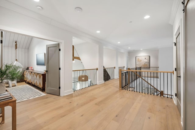 corridor featuring light hardwood / wood-style floors and ornamental molding