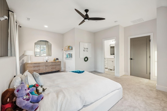 carpeted bedroom featuring ensuite bathroom and ceiling fan