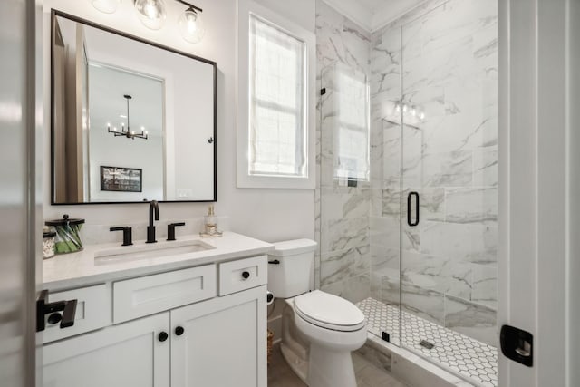 bathroom featuring toilet, an enclosed shower, vanity, and an inviting chandelier