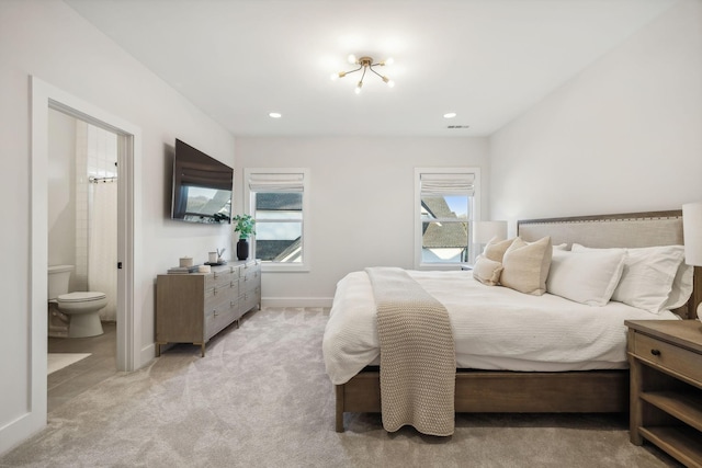 carpeted bedroom with ensuite bathroom