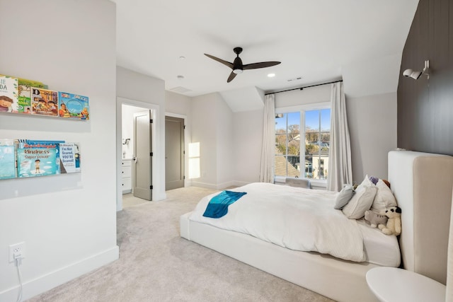 bedroom featuring ceiling fan, light colored carpet, and connected bathroom