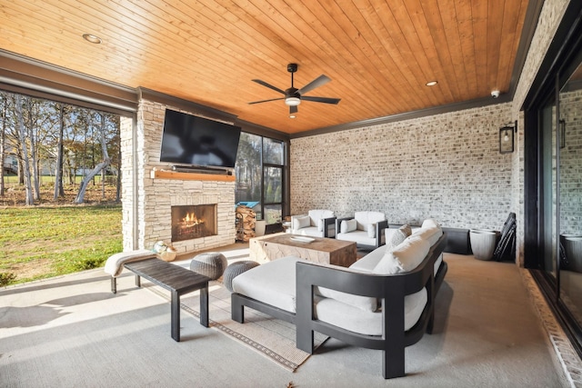 view of patio / terrace featuring an outdoor stone fireplace and ceiling fan