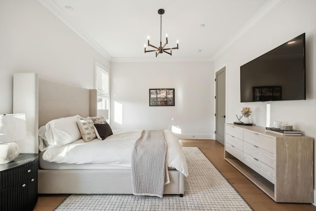 bedroom with wood-type flooring, a notable chandelier, and ornamental molding