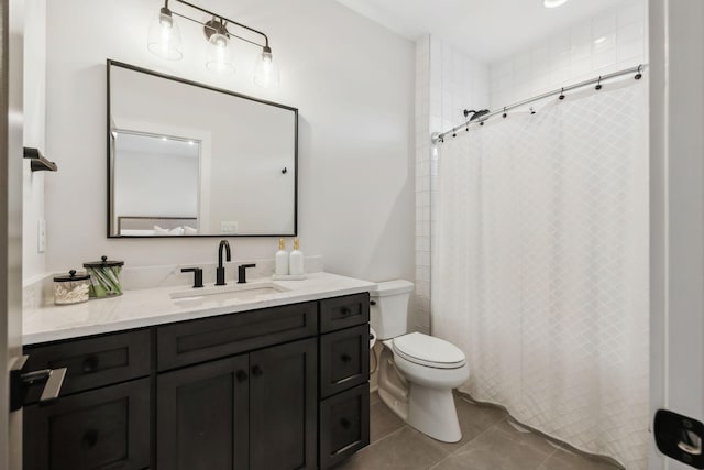 bathroom featuring tile patterned flooring, vanity, and toilet