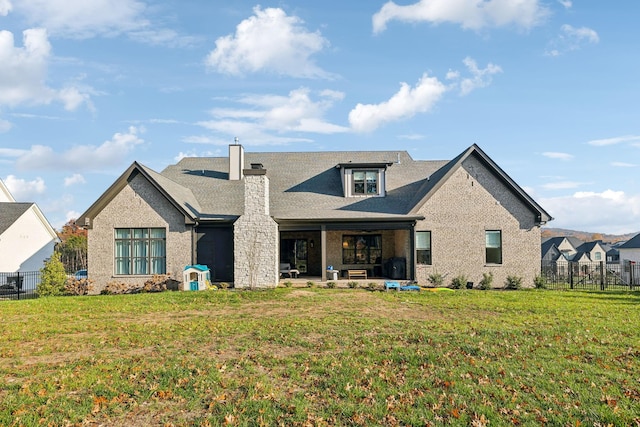 view of front of house featuring a front lawn and a patio