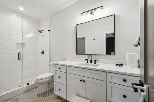 bathroom featuring toilet, vanity, tile patterned floors, and walk in shower