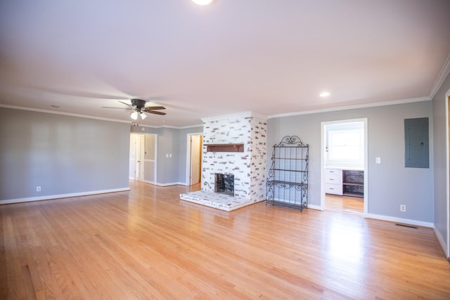 432 Menees Ln, Madison, TN 37115 - unfurnished living room with electric panel, a ceiling fan, a large fireplace, light wood-style floors, and ornamental molding