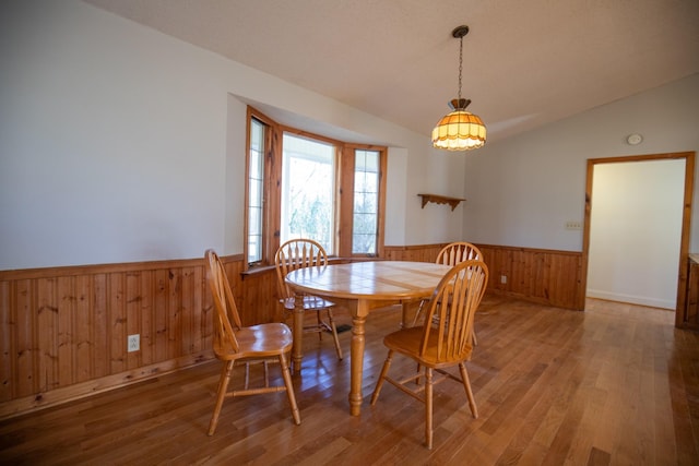 432 Menees Ln, Madison, TN 37115 - dining room with wainscoting, wood walls, wood finished floors, vaulted ceiling, and a chandelier