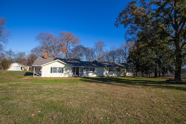 rear view of house with a yard