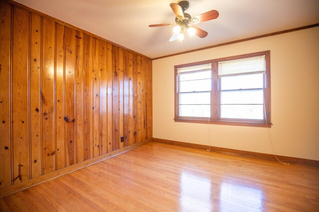 432 Menees Ln, Madison, TN 37115 - spare room with light wood finished floors, ornamental molding, baseboards, a ceiling fan, and wooden walls