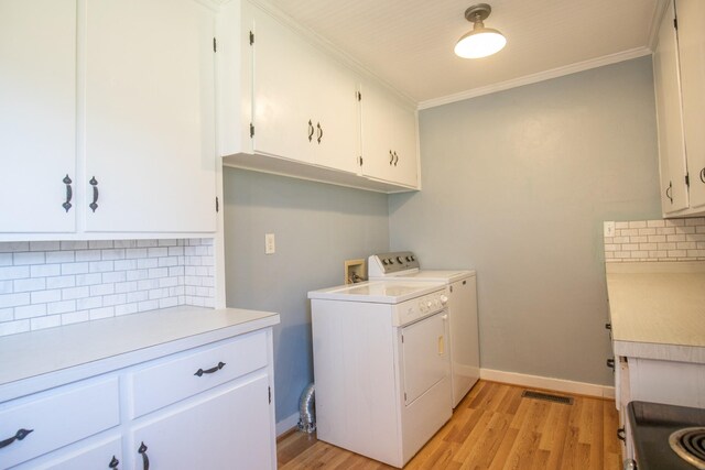 432 Menees Ln, Madison, TN 37115 - laundry room with cabinet space, light wood-type flooring, ornamental molding, washer and dryer, and baseboards