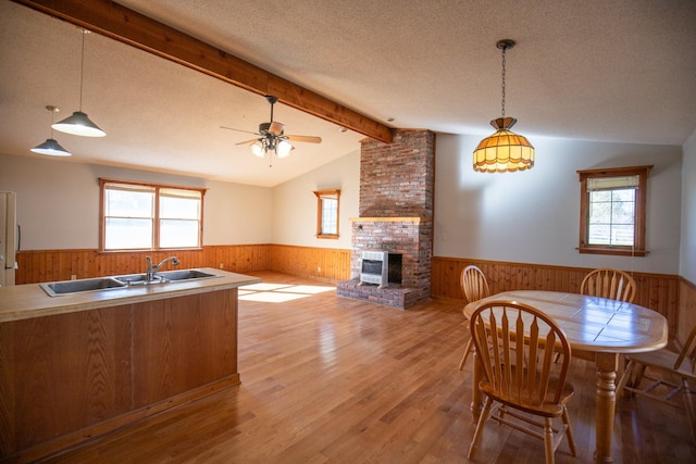 432 Menees Ln, Madison, TN 37115 - dining space featuring wainscoting, wooden walls, plenty of natural light, light wood-style floors, and a fireplace