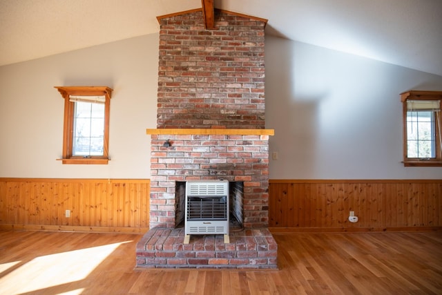 432 Menees Ln, Madison, TN 37115 - unfurnished living room with heating unit, lofted ceiling, healthy amount of natural light, wood finished floors, and wainscoting