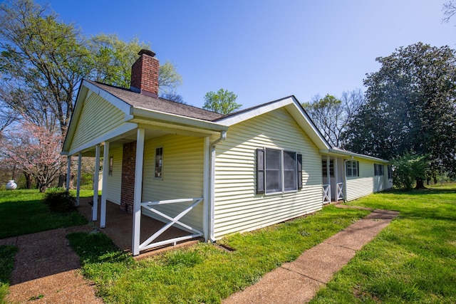 432 Menees Ln, Madison, TN 37115 - view of home's exterior featuring a chimney, a yard, a porch, and a shingled roof