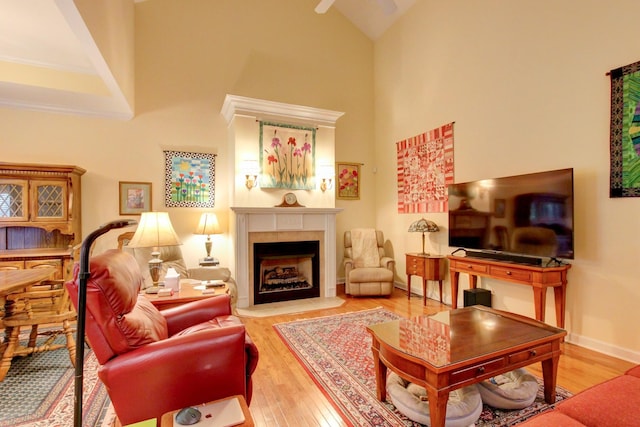 living room featuring high vaulted ceiling and hardwood / wood-style flooring