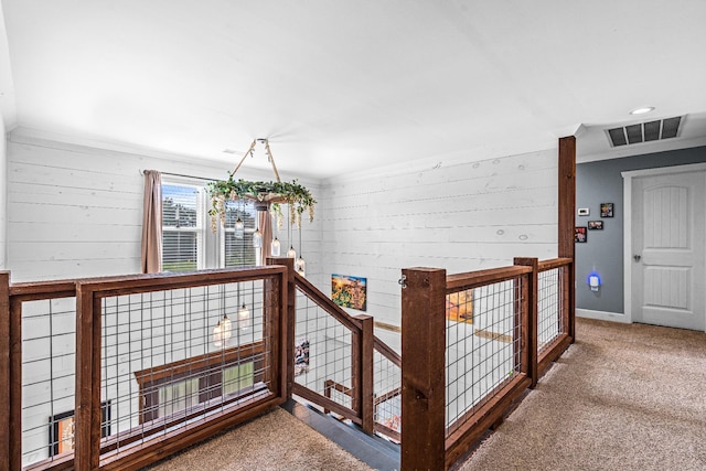 hall featuring carpet floors and crown molding