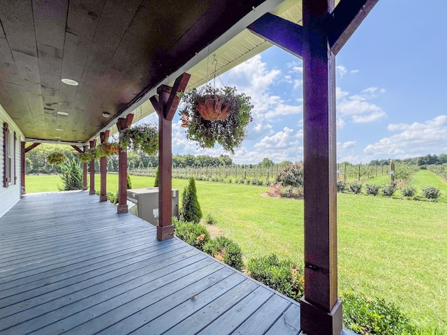 deck featuring a rural view and a yard