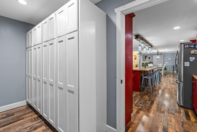 hall with dark hardwood / wood-style floors