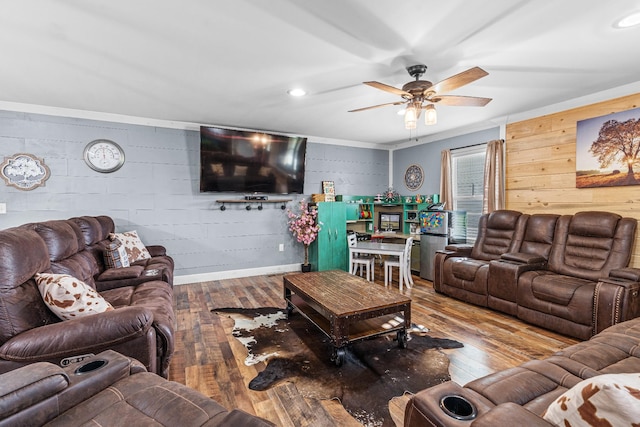 living room with ceiling fan, hardwood / wood-style flooring, and crown molding